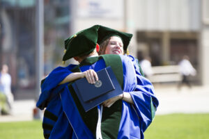 Two students embracing after LECOM Graduation