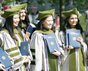 Group of female LECOM Graduates posing for picture with diploma's.