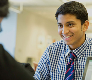 Male student smiling at another student