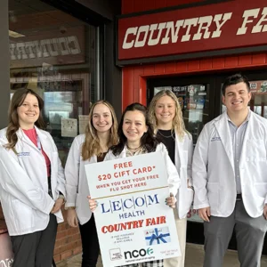 LECOM Pharmacy students holding award in front of Country Fair Store